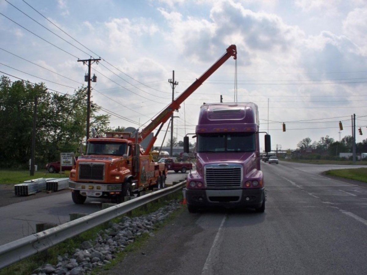 Wrecker assisting a semi along the highway